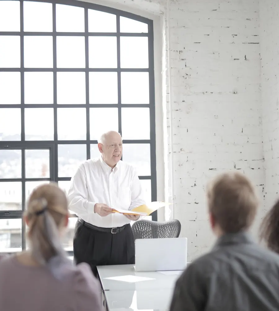 A leadership team working through a plan in a boardroom