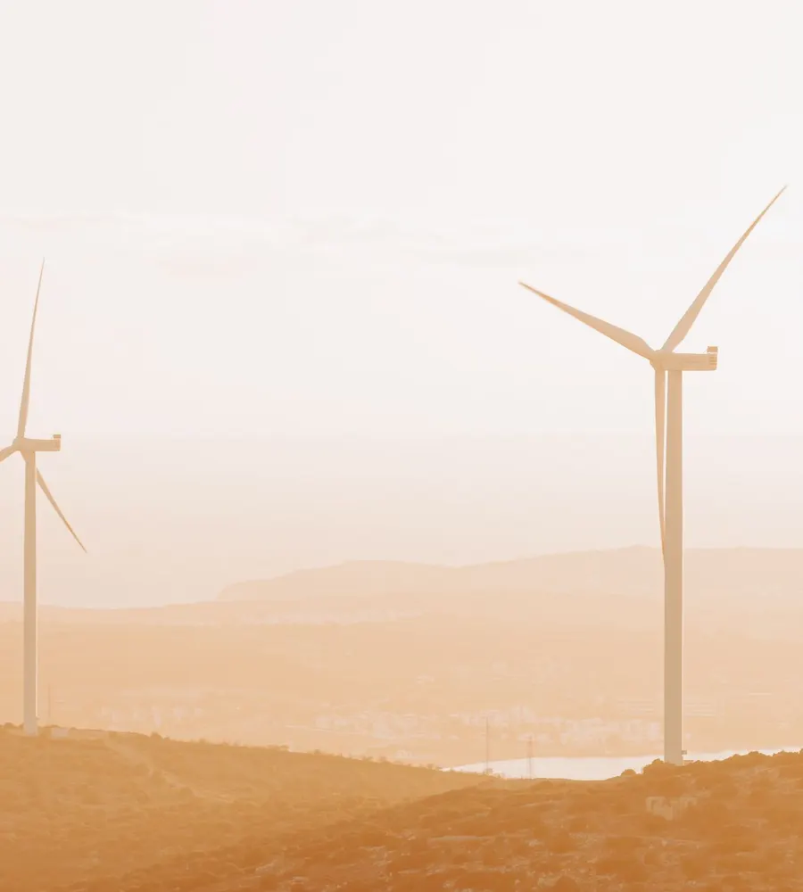 Wind turbines against a sunset sky